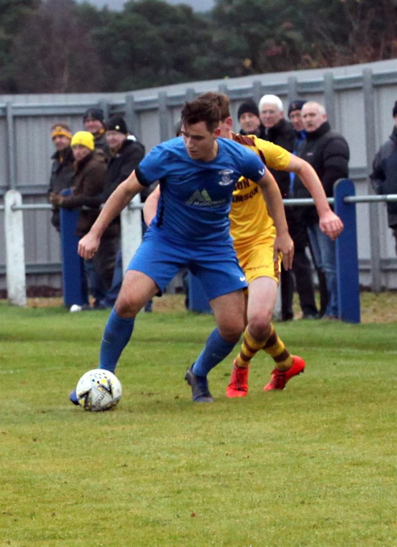 Strathspey Thistle's James McShane shields the ball.