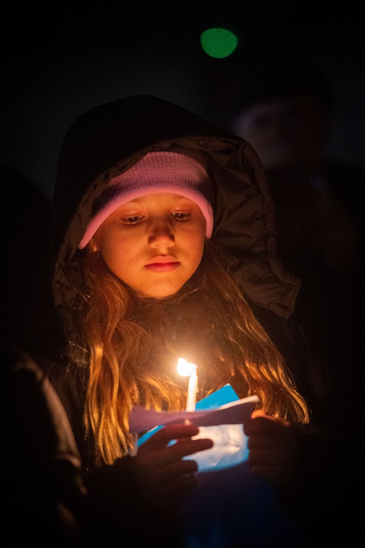 Girl with lit candle. Picture: Callum Mackay..
