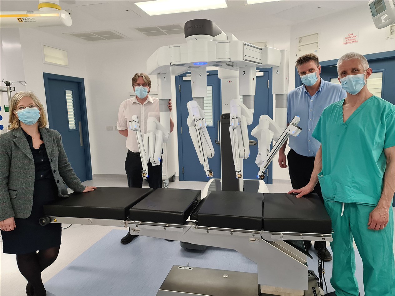 Emma Watson, Deputy Medical Director (Acute); Alan Grant. Clinical Director for Surgery, Anaesthesia and Critical Care; Kenny Oliver, Service Manager for Theatres; and Colin Richards, Consultant Colorectal Surgeon next to DaVinci Xi.