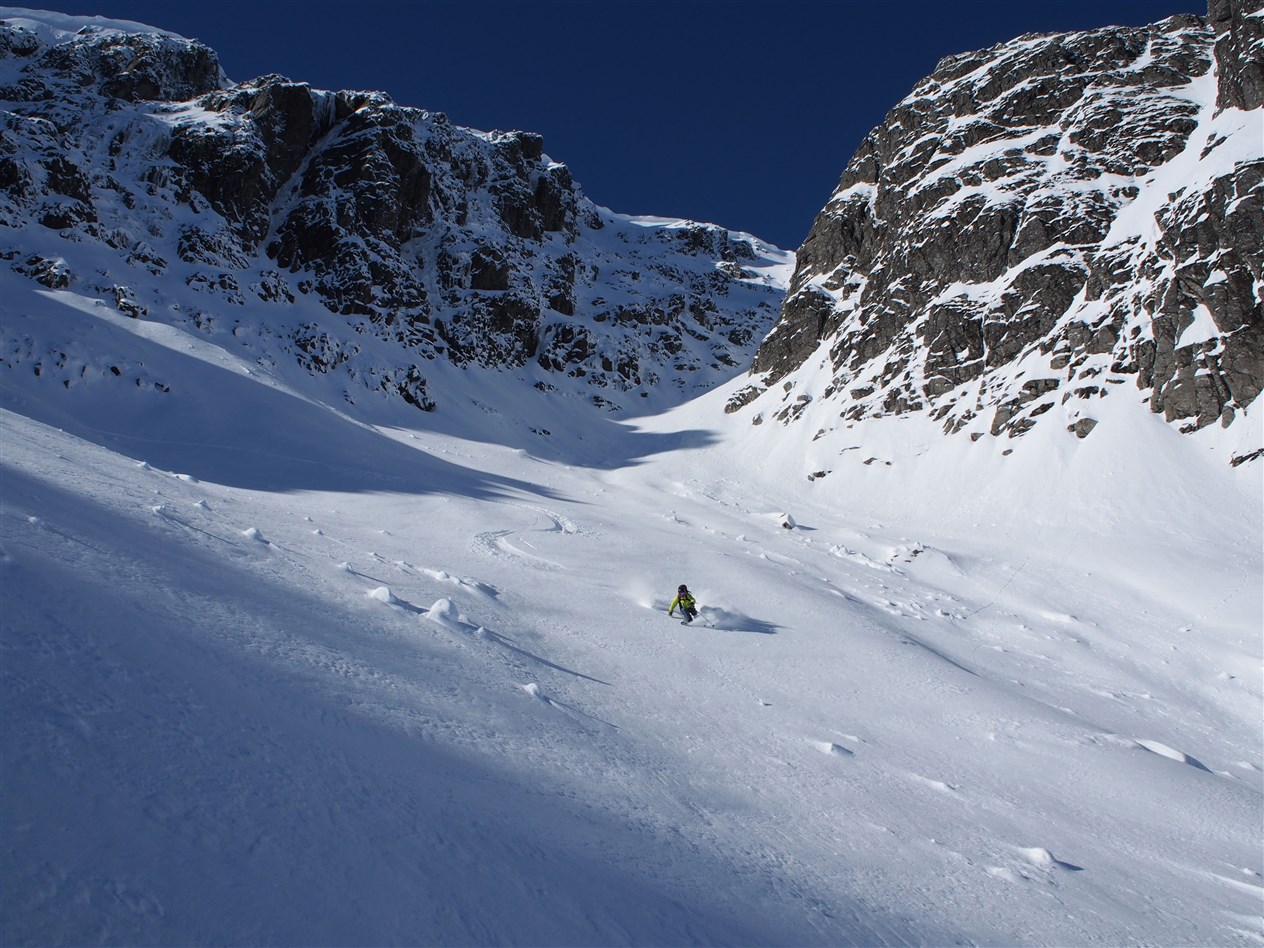 Taking advantage of a one-day-window to ski powder below Upper Martini Couloir on Aonach Beag. Skier: Kenny Biggin. Photo: Neil Muir