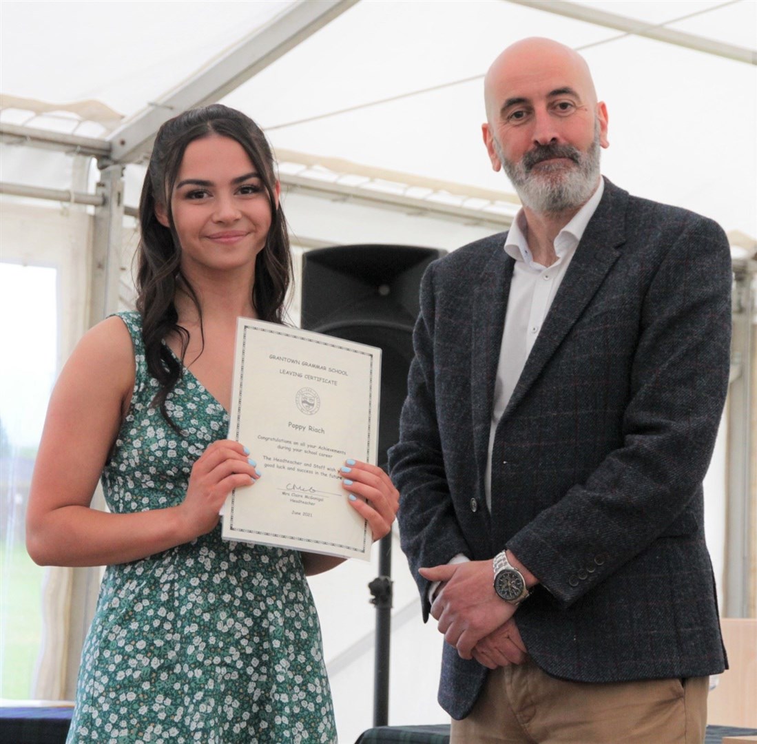 Poppy Riach shows off her prize-winner's certificate.