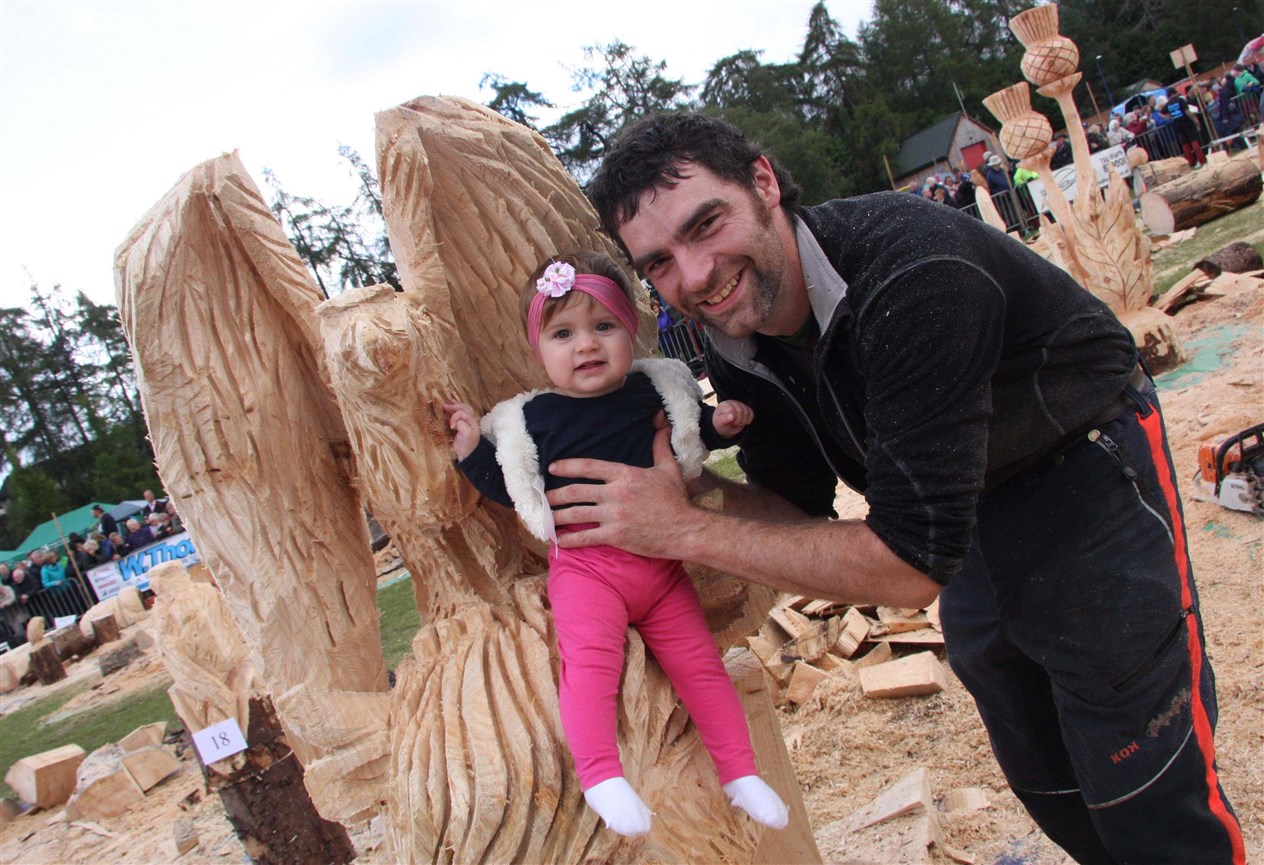 Samantha Bateman gets a seat on her dad Uinnsinn's carving, 'Highland Totem'.