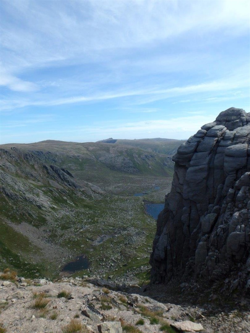 Lochan Dubh peeks from behind the cliffs
