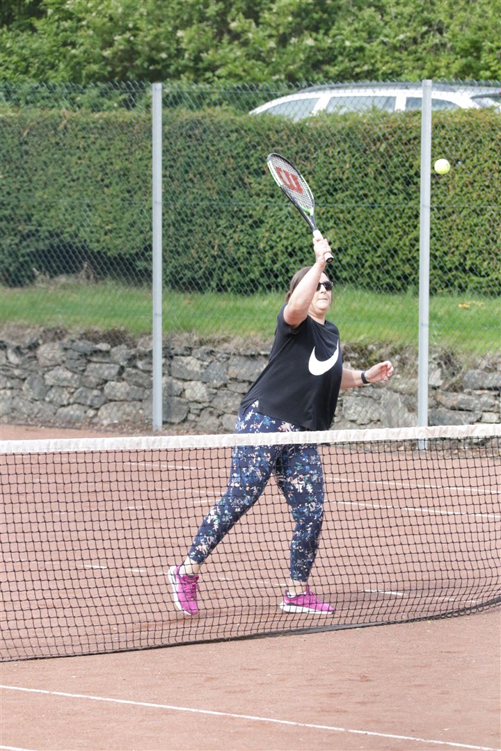 Lisa Carlisle puts away a volley at the net.