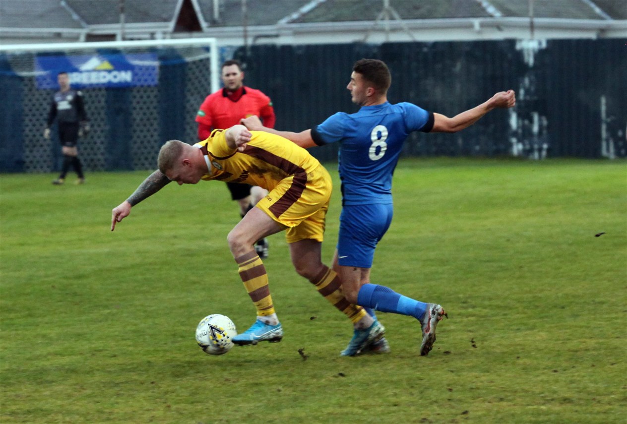 Strathspey Thistle defender Cameron Lisle (right) tussles for the ball.