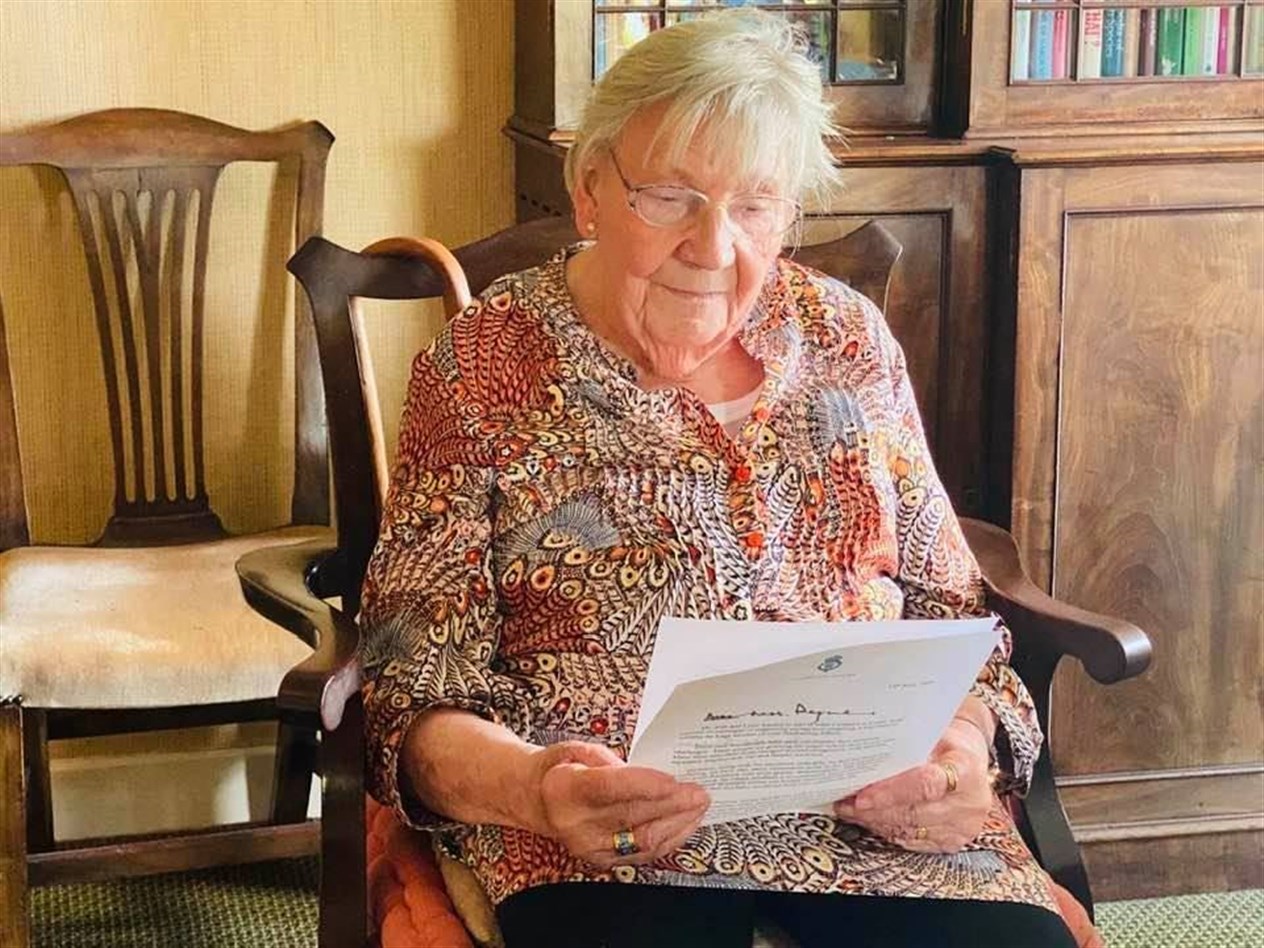 Margaret Payne reading her letter from Prince Charles, Duke of Rothesay.