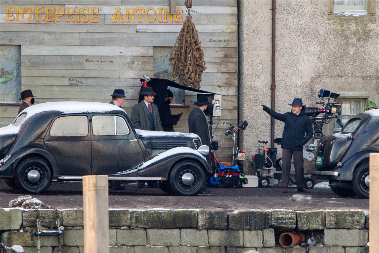 Michael Gray (played by Finn Cole) is surrounded by gangsters on set during a break in filming at Portsoy. Picture: Daniel Forsyth