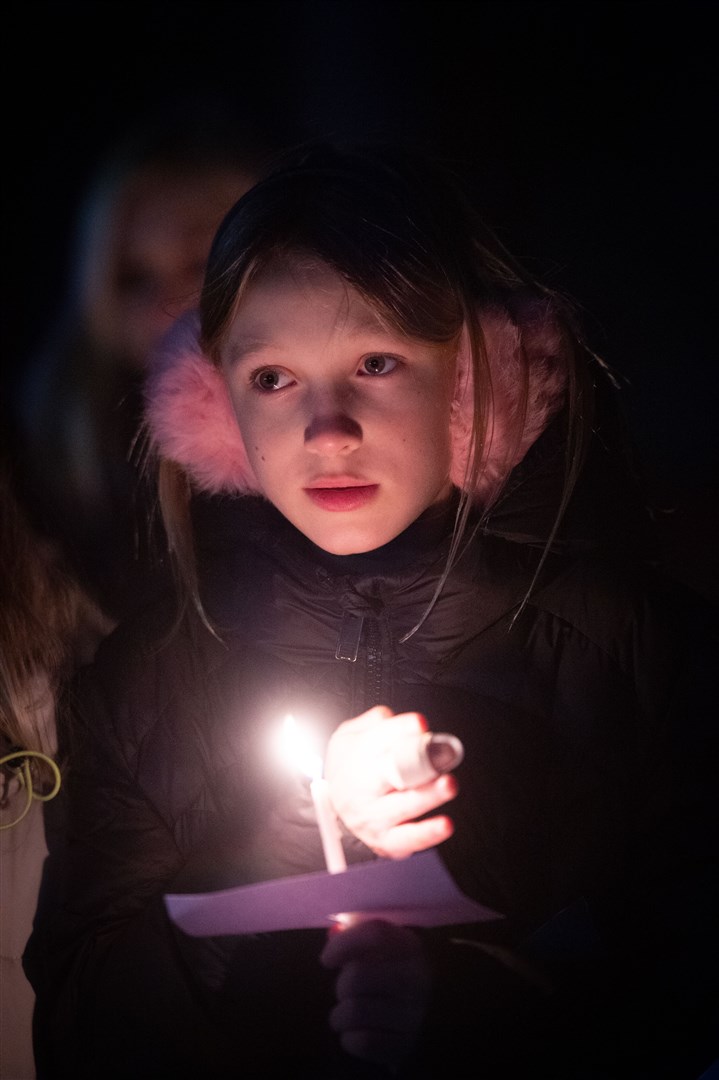 Girl with lit candle. Picture: Callum Mackay..