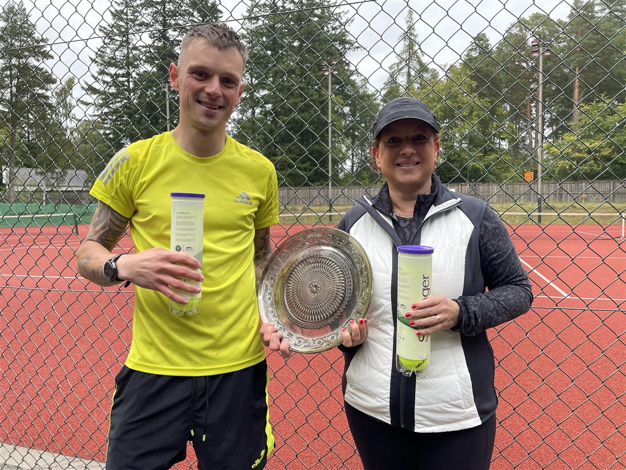 RAIN DID NOT STOP PLAY: Plate winners Colin Macleod and Kim Beattie.