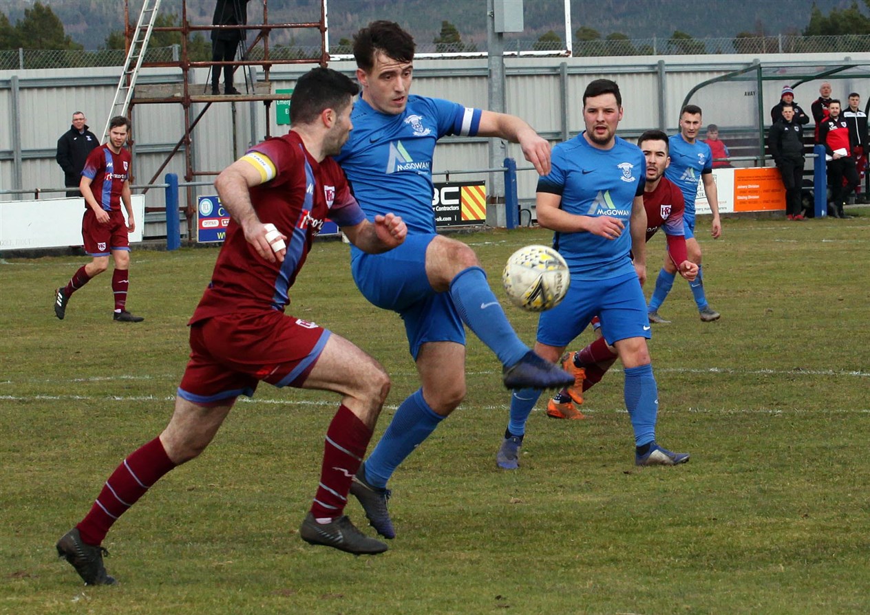 Jags' midfielder James Mcshane gets to the ball before Keith captain Cammy Keith.