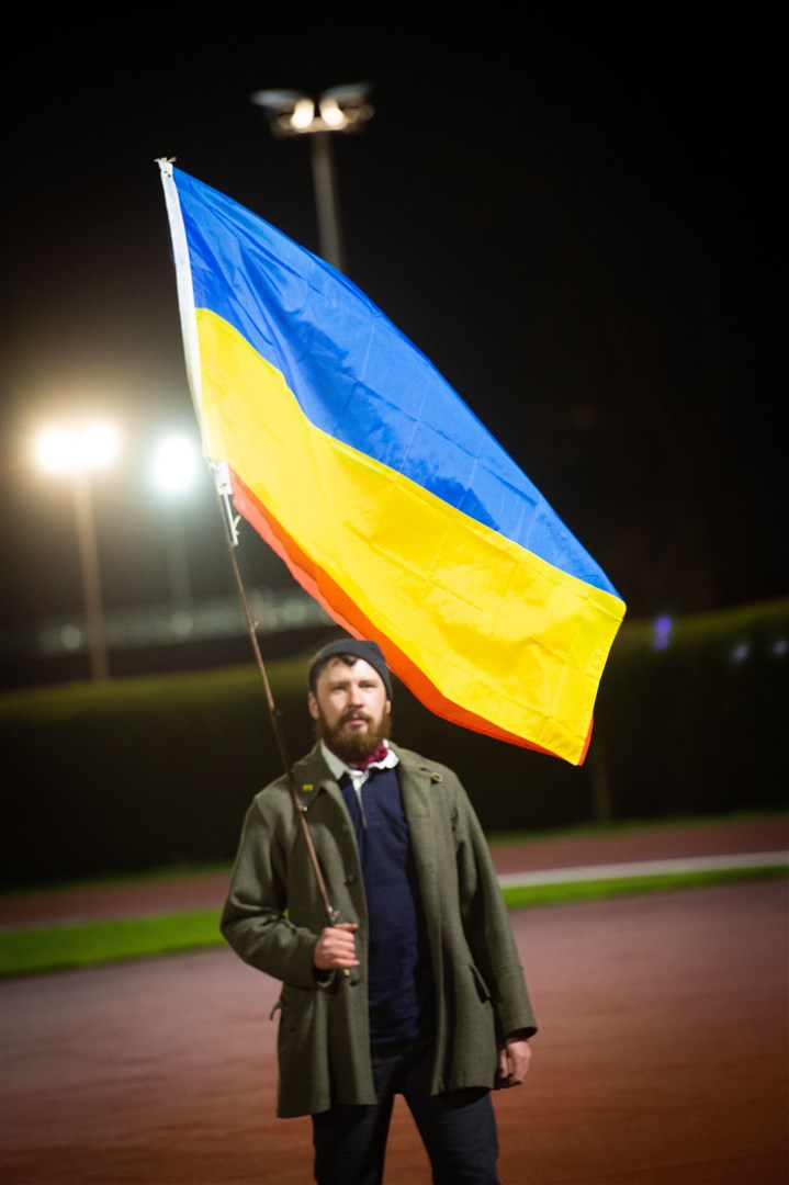 Man holding flag. Picture: Callum Mackay..