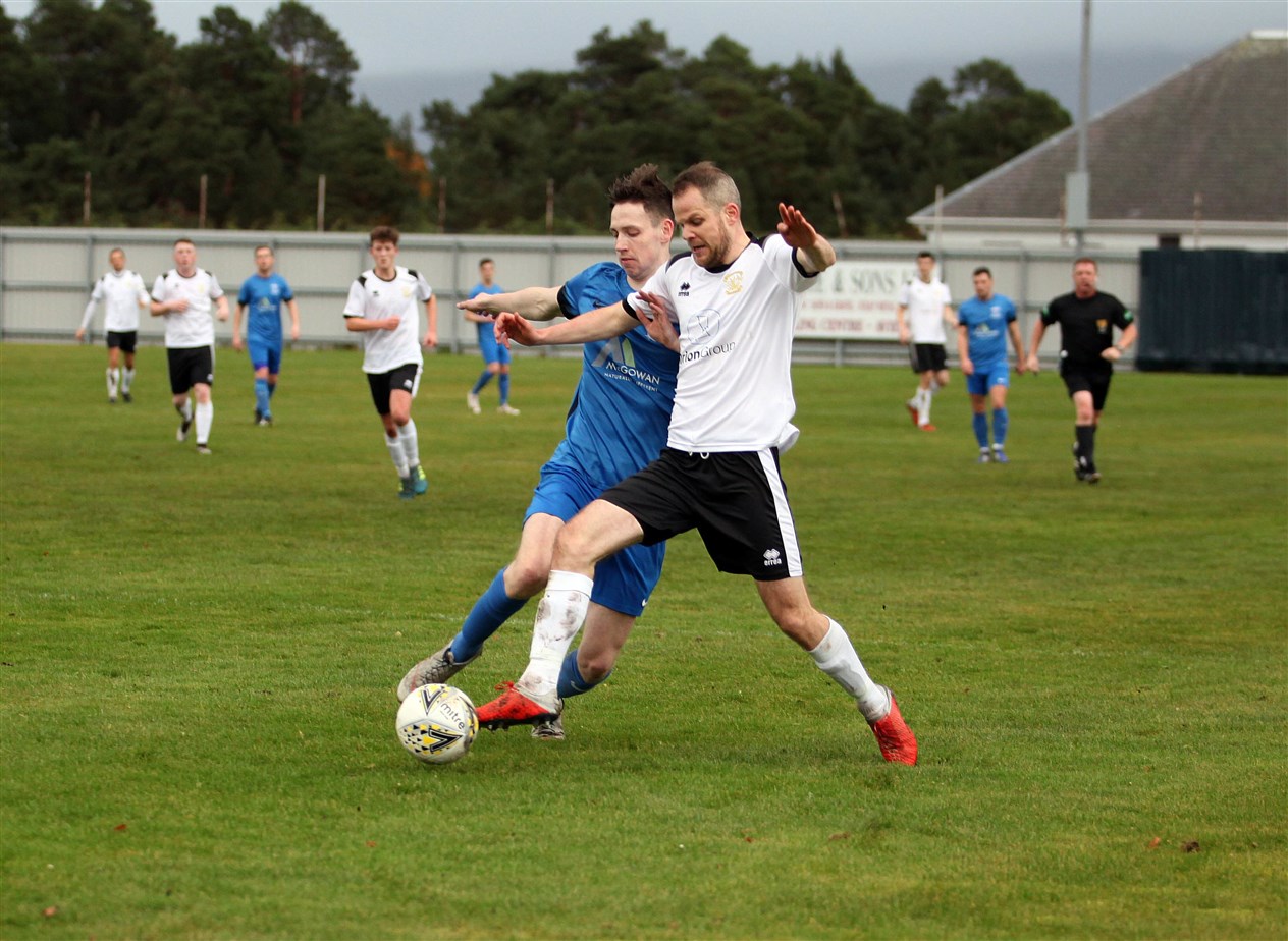 Alan Hardwick (left) gets a toe to the ball for the Jags.