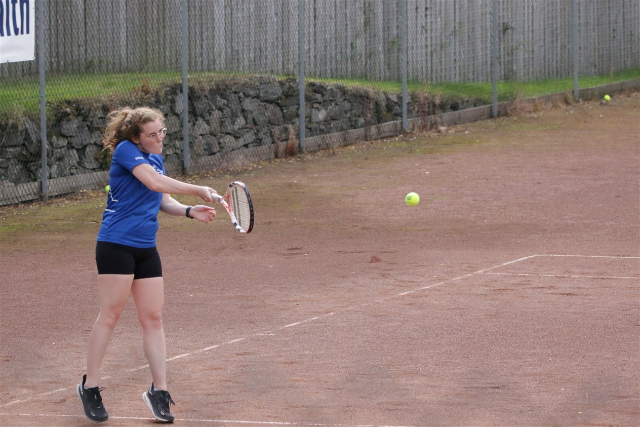 A side on view of the action at the Kingussie courts.