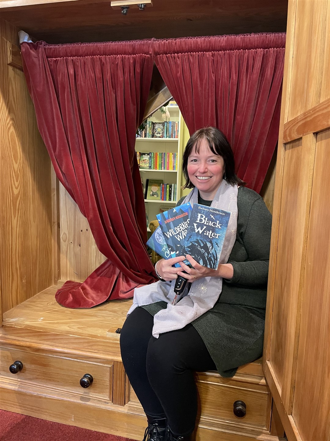 The writer Barbara Henderson on a visit through the wardrobe to the children's bookshop space.