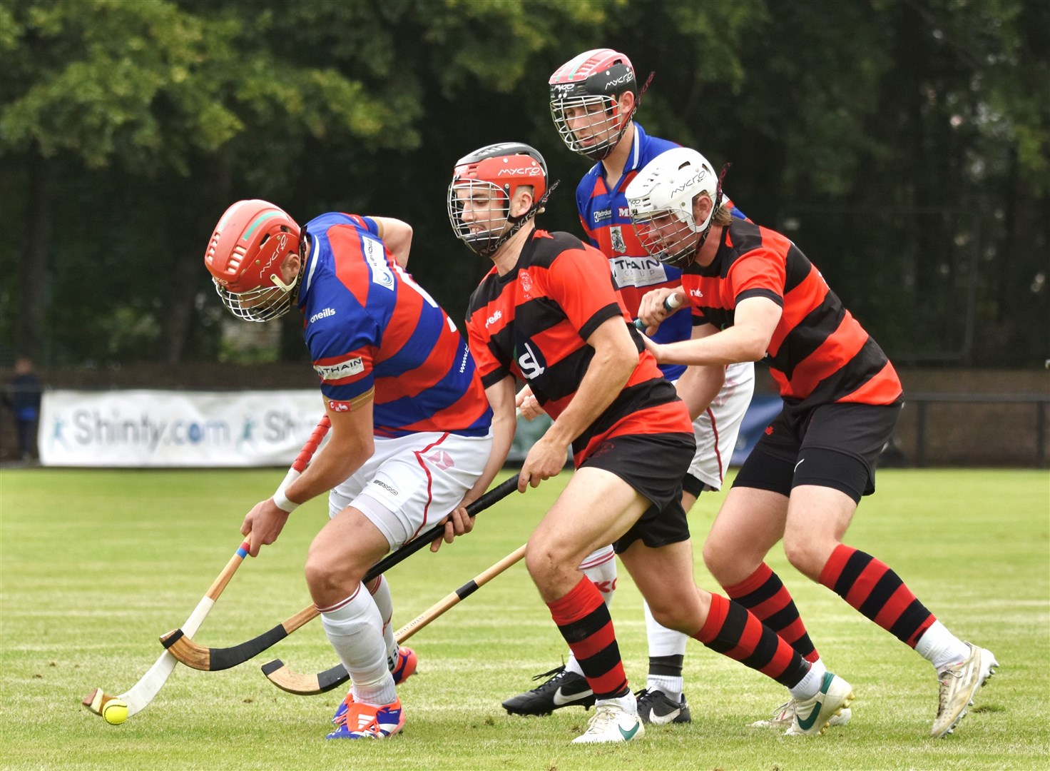 Eyes down on the ball during a midfield battle in the final between Kingussie and Oban Camanachd at Mossfield.
