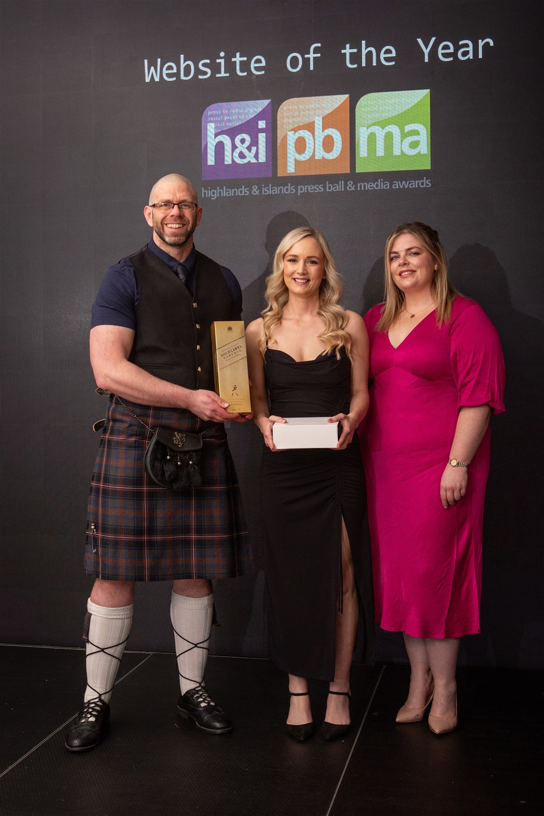 Andy Dixon and Sarah collect the award for website of the year. Picture: Alison Gilbert