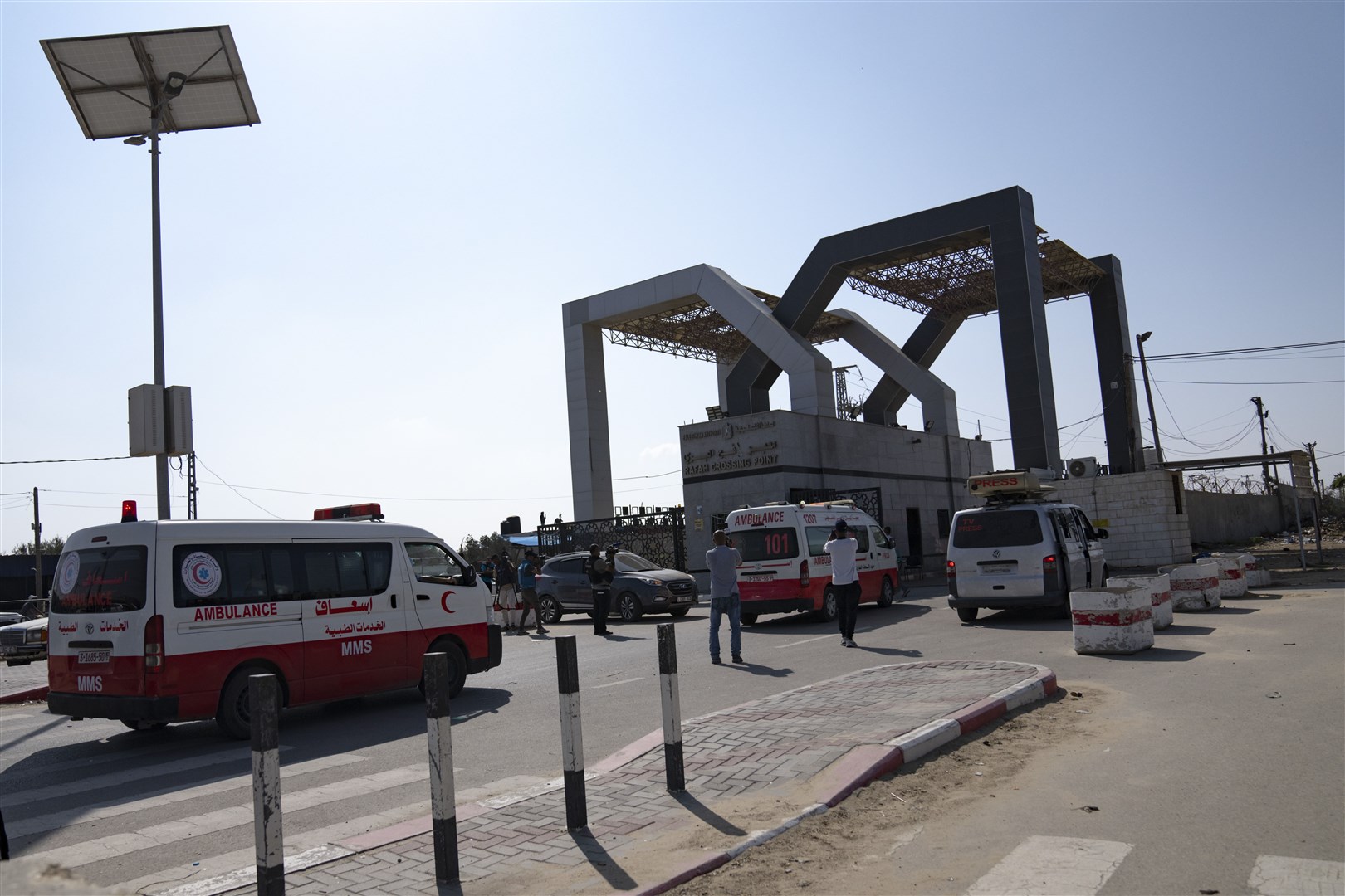 Ambulances with Palestinians wounded in the Israeli bombardment of the Gaza Strip arrive at the Rafah border crossing (Fatima Shbair/AP)
