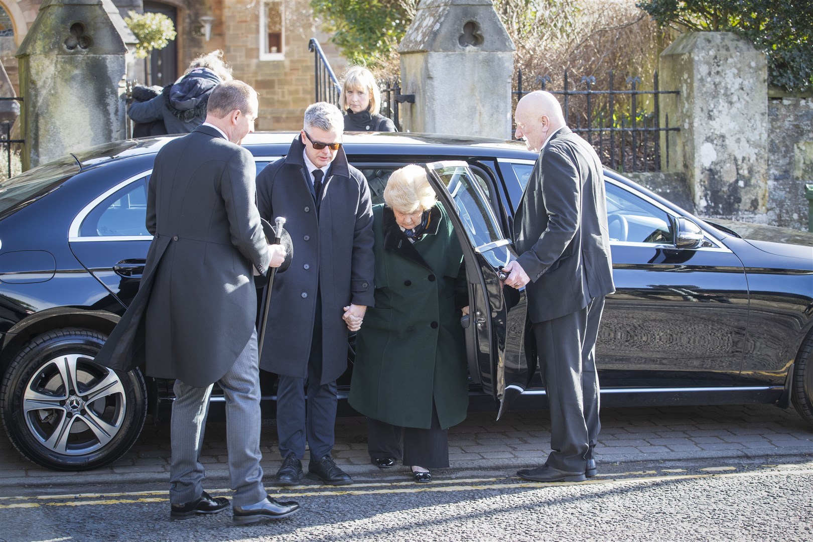 Widow Shirley Devine (centre) arrives for the ceremony (Jane Barlow/PA)