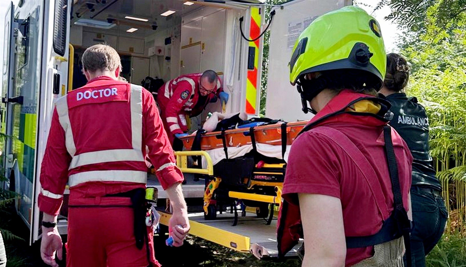 Mr Hamilton is carried into the waiting ambulance.