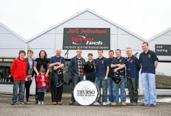Andrew Harvey accepts the covers from Mr Plowman. Also pictured are: Alan’s son Murray, Chloe Smith, Karen Coghill and daughter Morven, Grant Coghill, Amanda Campbell, Robbie Campbell, Mark Moodie, Nicol Simpson and Andrew Watt.