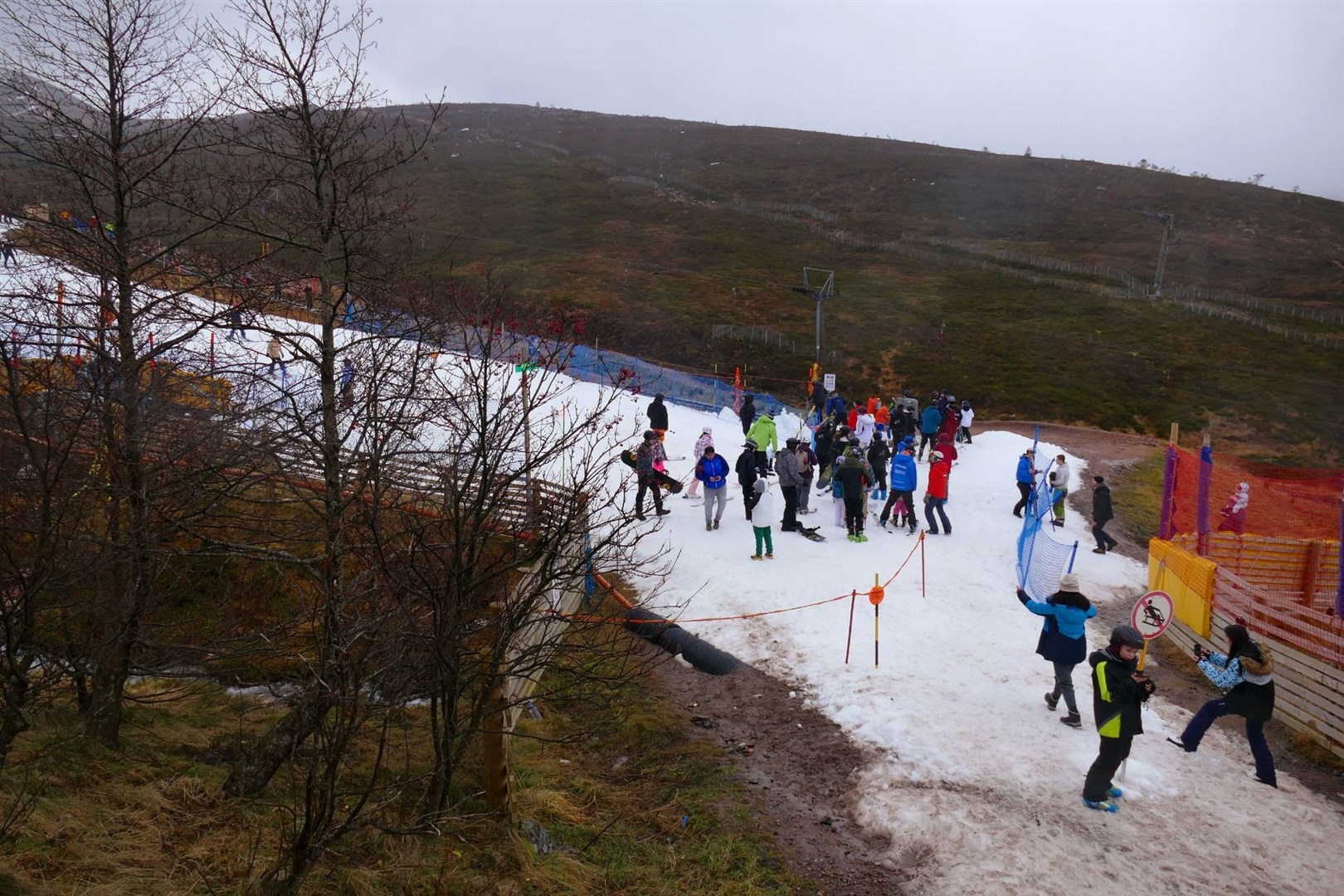 HEIGHT OF FRUSTRATION: The higher slopes have not a trace left of snow, while today's visitors huddled on the last remains left at the base station.