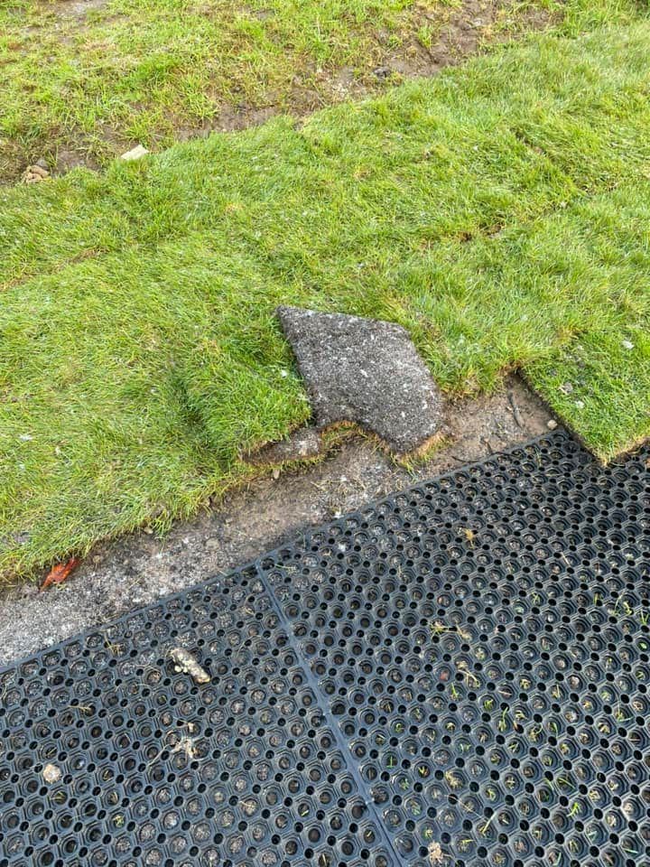 Ripped up: new turf just laid has been uplifted along the borders of the play area
