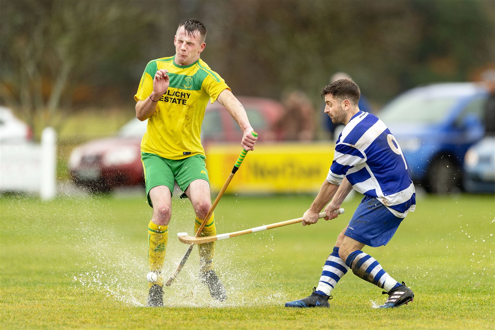 Rhuaridh Macdonald (Glengarry) tries to block the swing of Drew Macdonald (Newtonmore).