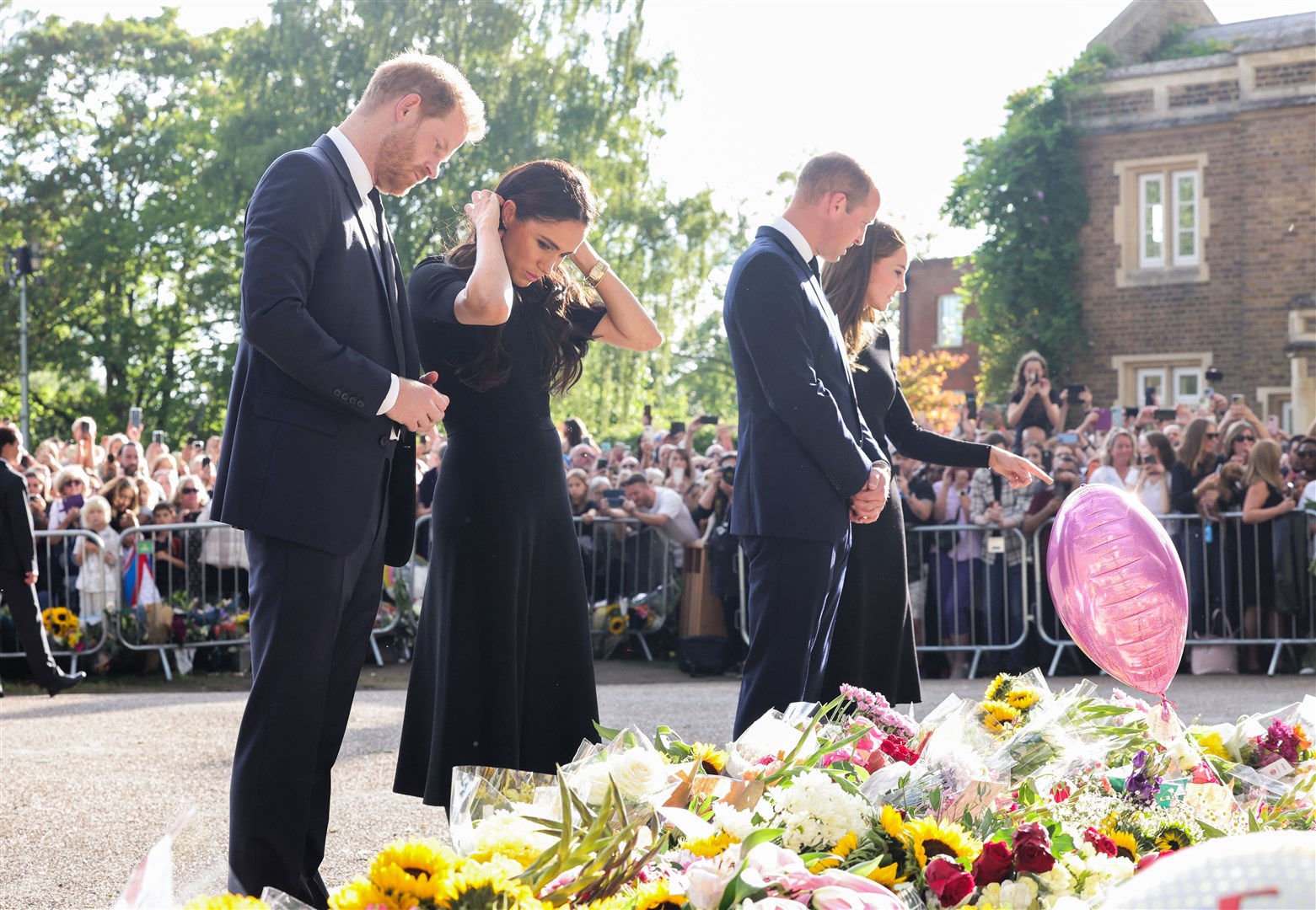 The Duke and Duchess of Sussex, and the Prince and Princess of Wales view floral tributes outside Windsor Castle (Chris Jackson/PA)