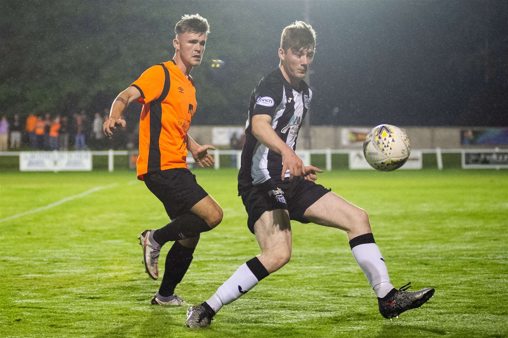 Elgin City's Ben Cormack shields the ball from Rothes' Shane Harkness (left) who has just joined Strathspey Thistle on loan. Picture: Daniel Forsyth.