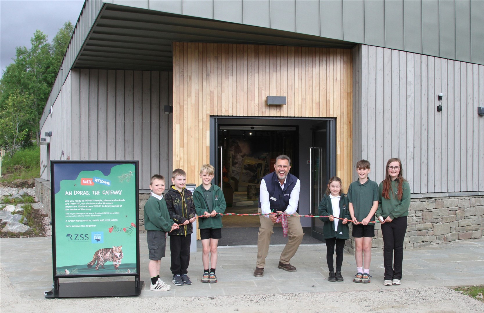 RZSS chief executive David Field cuts the ribbon with the assistance of Alvie Primary School pupils Malky Mainland, Murray Mainland, Mackenzie Morris, Hunter Morris, Talia Leil and Leah Keith.