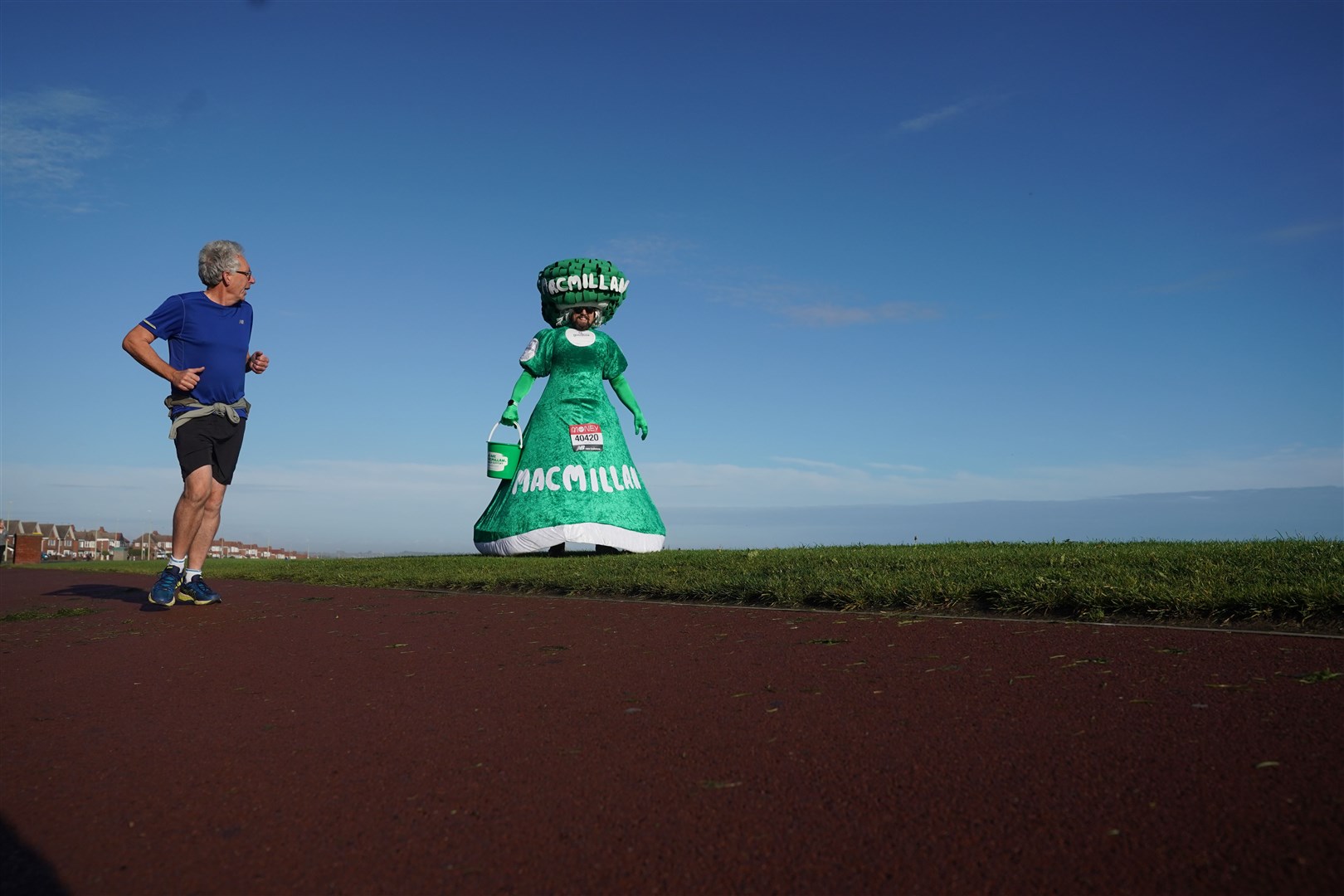 Runners including Colin Burgin-Plews, 52, of South Shields, taking part in costume in aid of cancer charity Macmillan, are undertaking the marathon on their own routes in the 2020 virtual event (Owen Humphreys/PA)