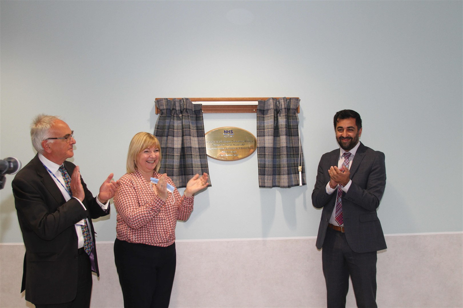 Professor Boyd Robertson, NHS Highland chairman, and Pam Dudek, NHS Highland chief executive, applaud after Health Secretary Humza Yousaf officially opens the hospital at Dalfaber in Aviemore.