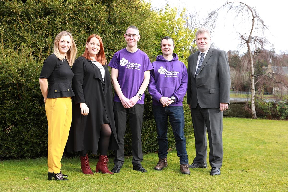From left: Lindsey Moodie and Jessica Taylor from the university’s social committee, Michael Parkes and Kenny Wright from Alzheimer Scotland, and Principal and Vice-Chancellor Professor Crichton Lang.