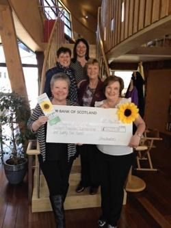 Lorraine MacPherson, Janet Hartree and Jean Gordon hand over the cheque to the charity