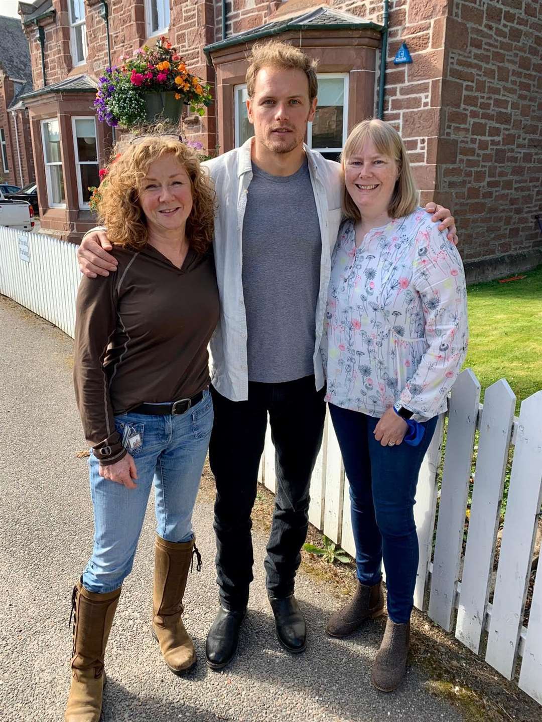 Sam Heughan was photographed as he filmed for Men in Kilts around the Highlands. He is pictured here with Inverness Outlanders Caroline Keith and Mhairi Jarvis in Inverness.