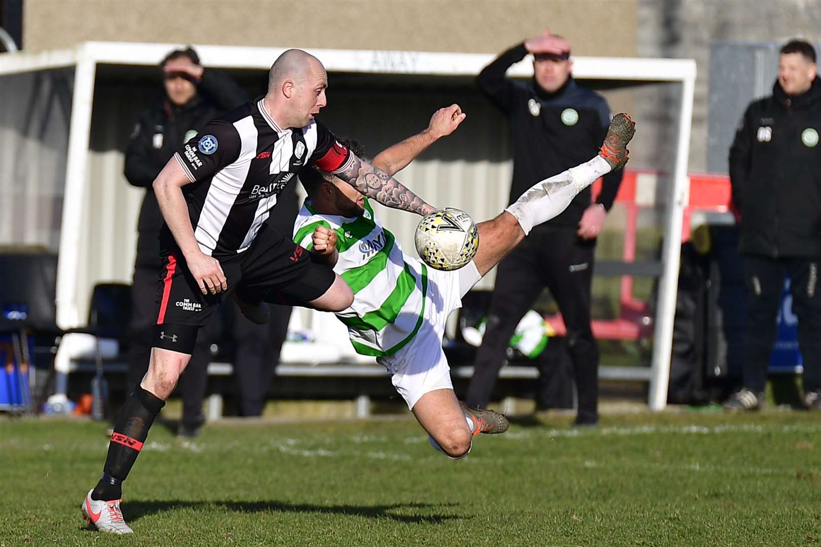 Buckie's Sam Urquhart is in mid-air as Wick's Danny Mackay concentrates on the ball. Picture: Mel Roger