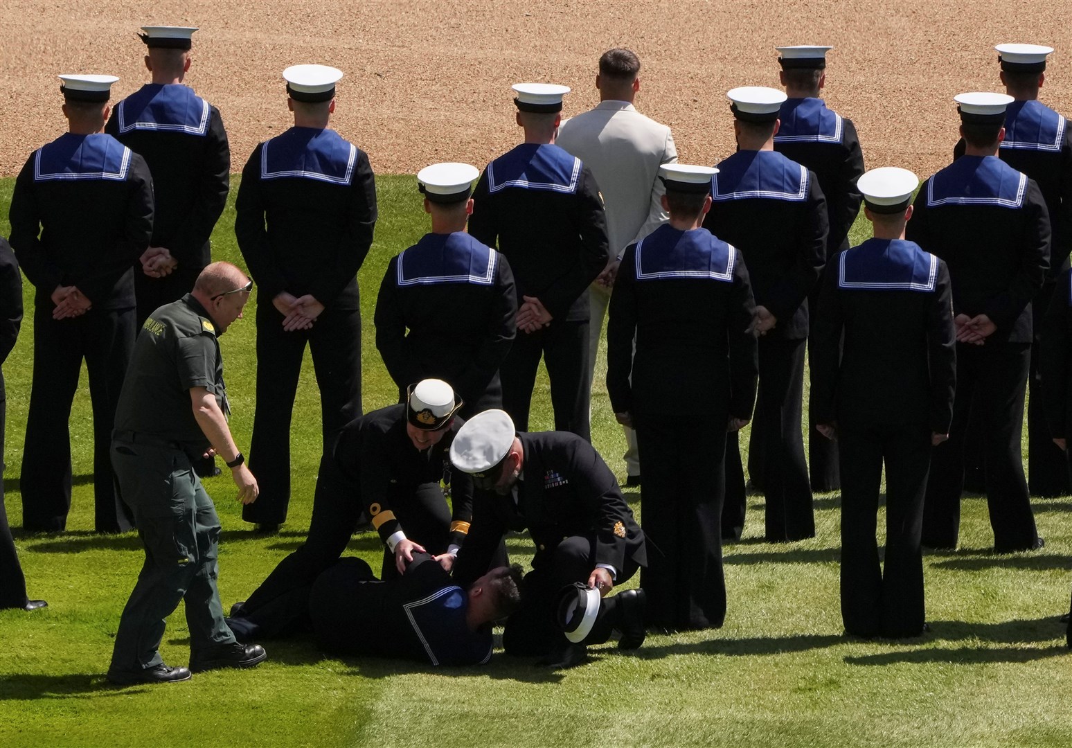 A member of Royal Navy who collapsed is attended to during the ceremony (Maja Smiejkowska/PA)