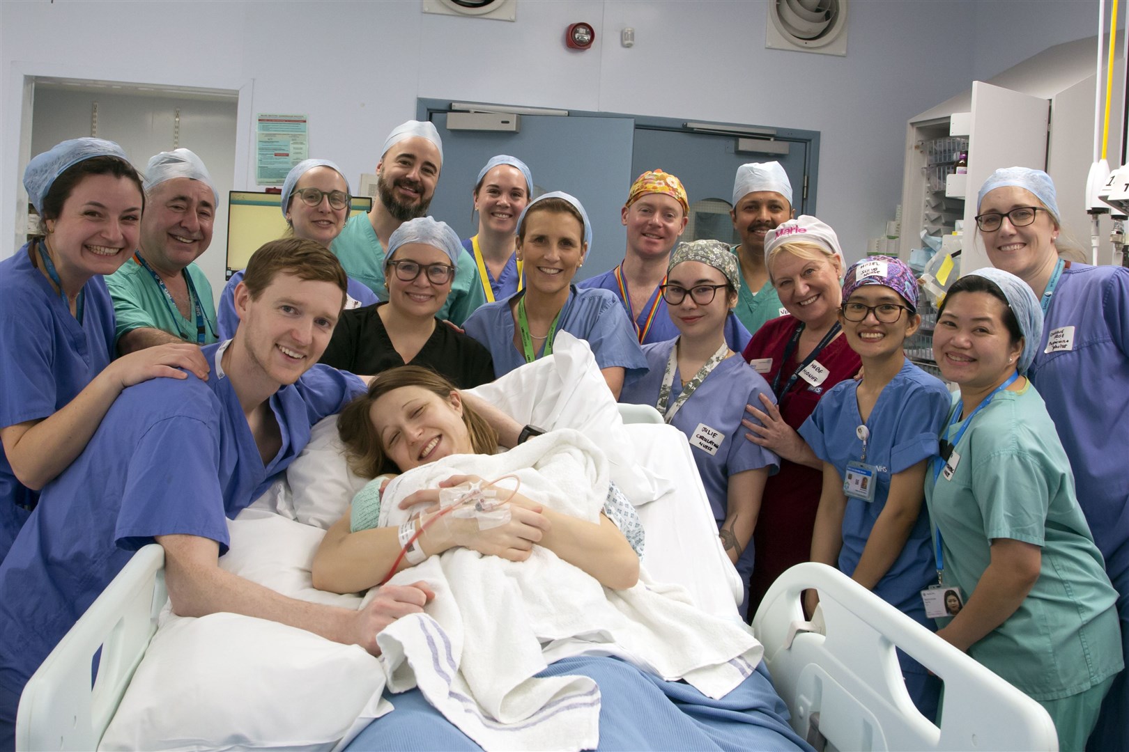 Grace and Angus Davidson with the hospital teams who enabled Amy’s birth on February 27 (Womb Transplant UK/PA)