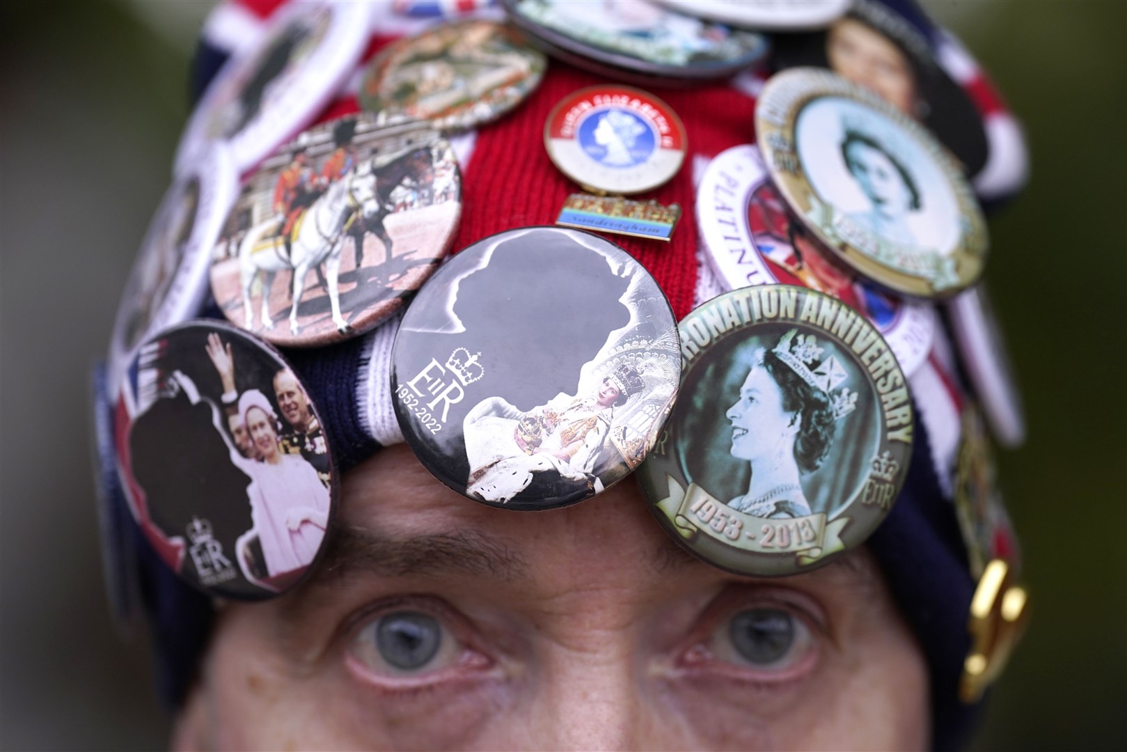John Loughrey wearing a hat with various badges on outside Buckingham Palace (Danny Lawson/PA)