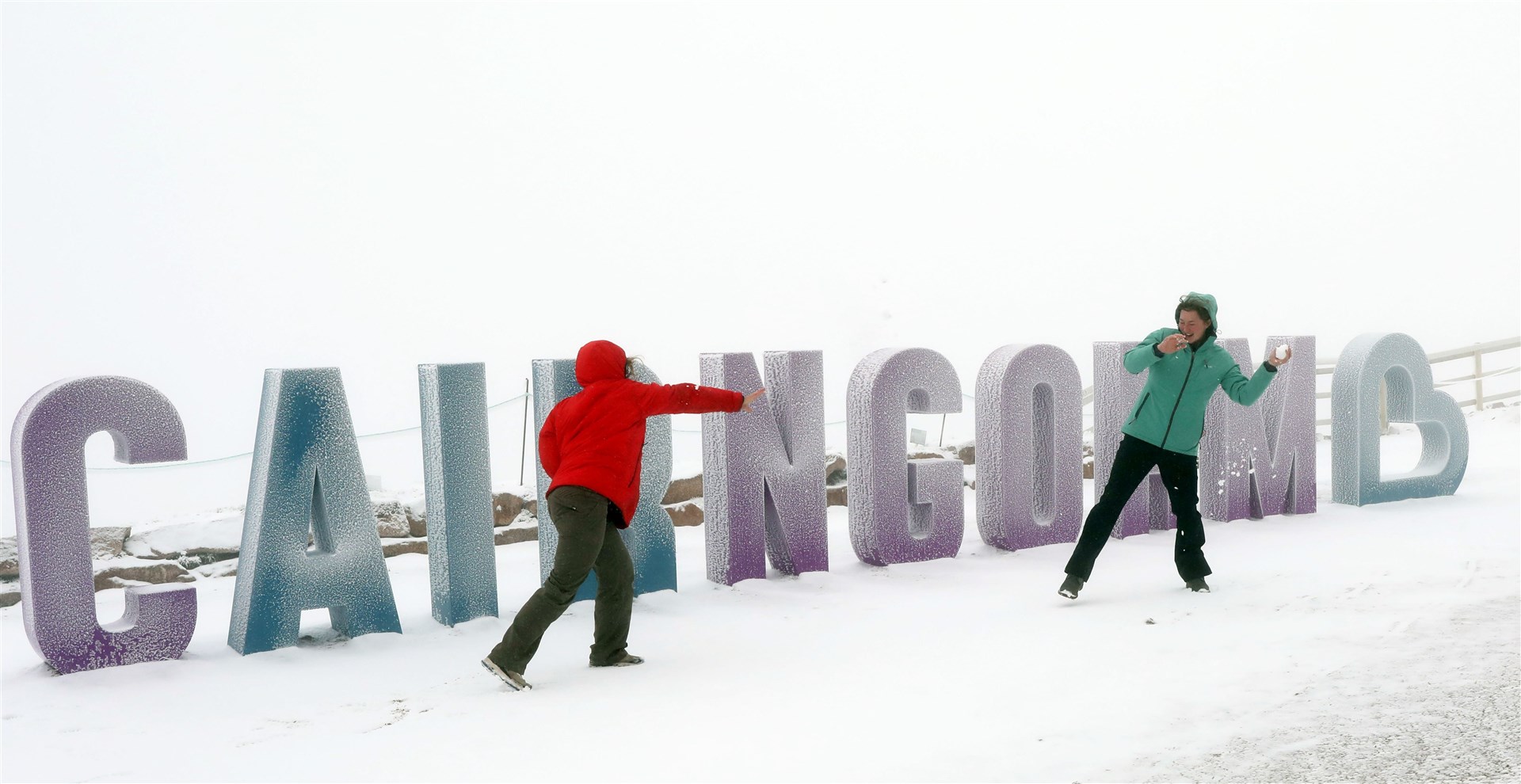 Alana Invernon and Olivia Greenwood in the snow outside the Ptarmigan restaurant at Cairngorm Mountain on Sunday. Picture: Peter Jolly.