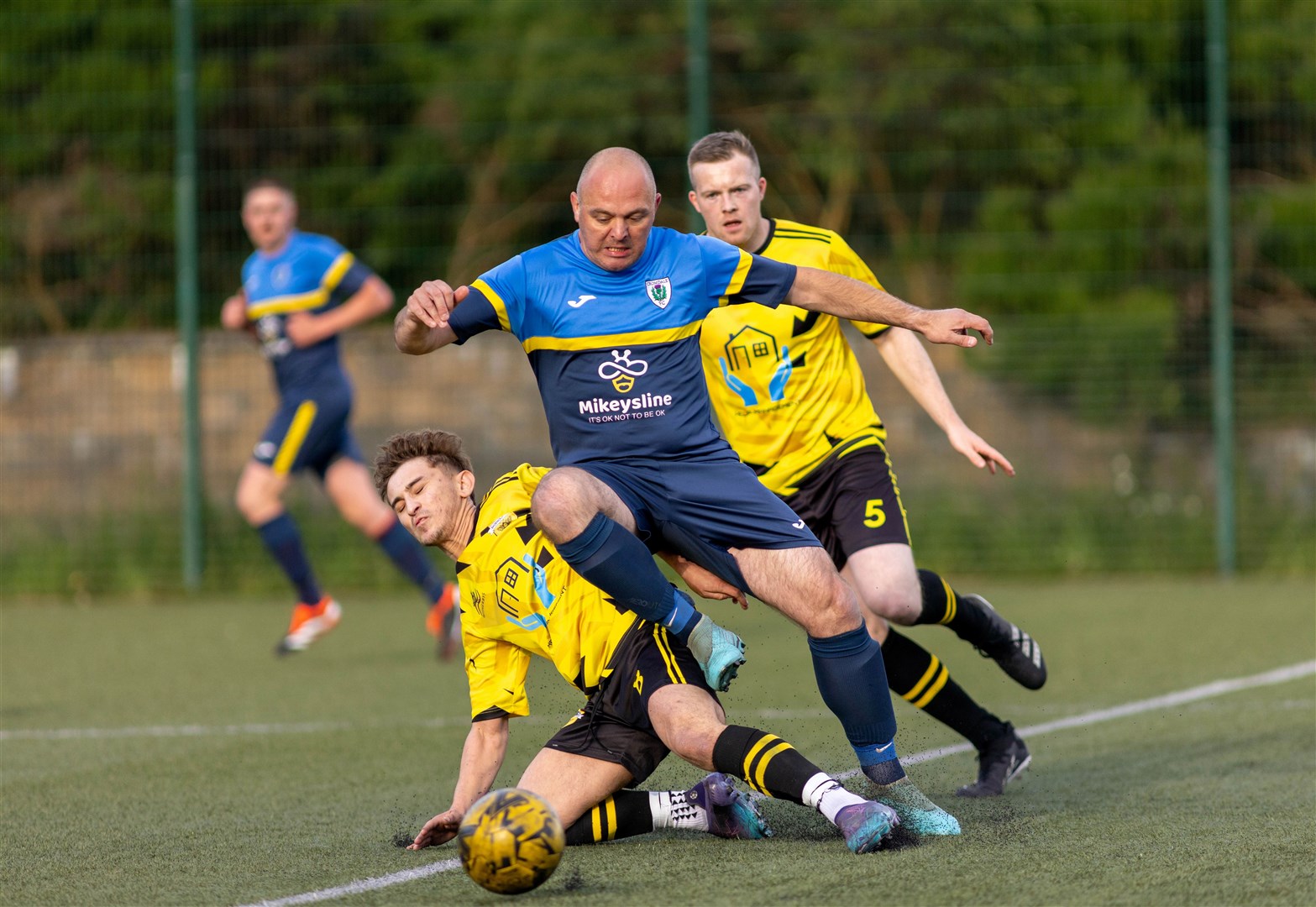 Iain Brooks (centre) comes under pressure from Badenoch United's Ty Cobb and Sam Cairns in the cup match. Picture: Aidan Woods.