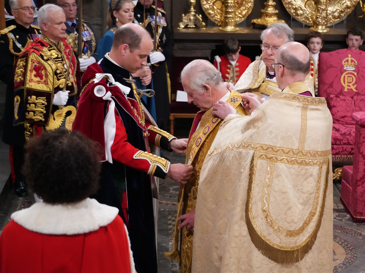 The Prince of Wales placing the Stole Royal on his father the King during his coronation ceremony (Victoria Jones/PA)