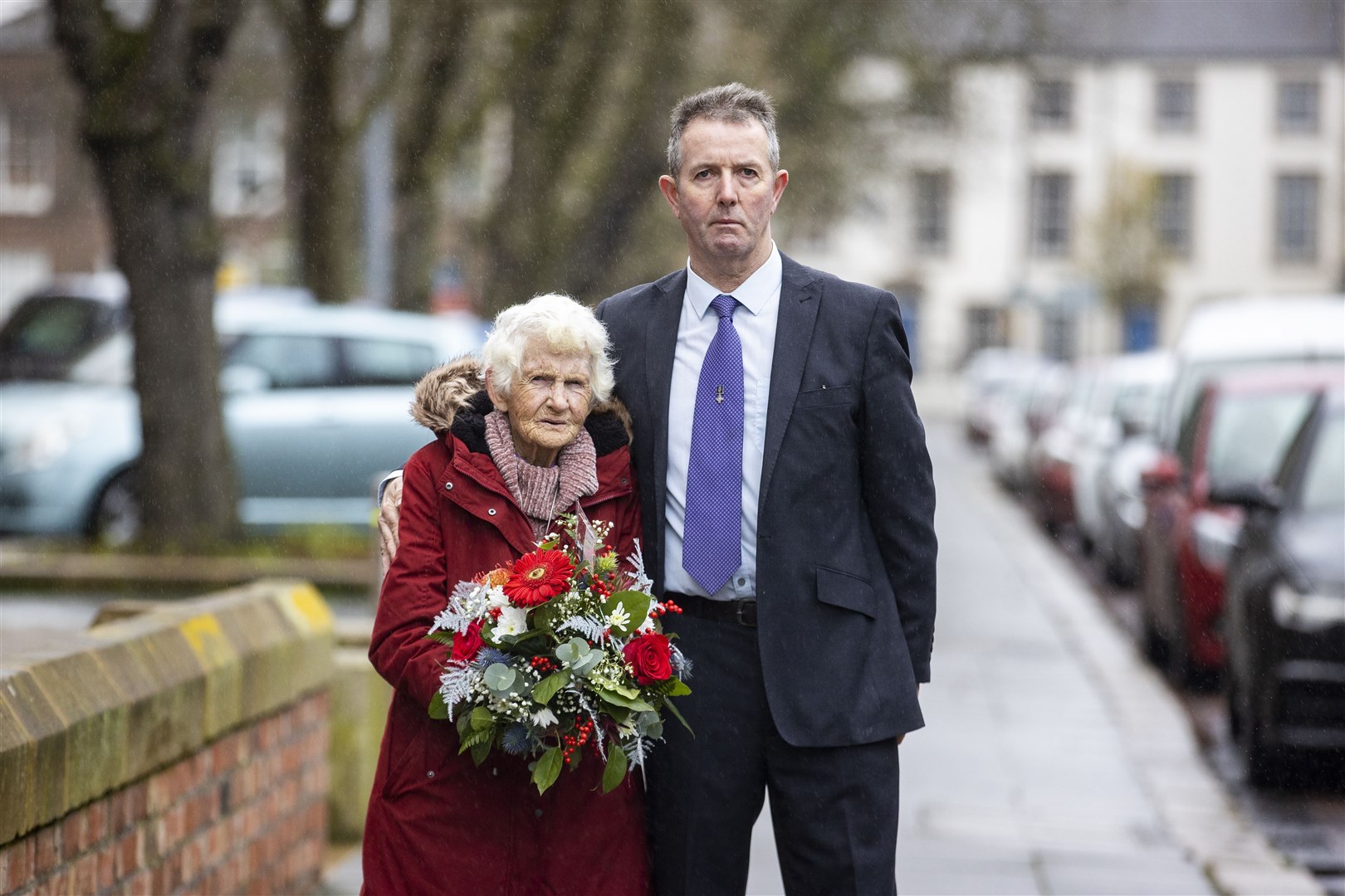 Maura Babington, widow of James Henry Babington, with their son Marcus during a wreath laying at Queen’s University for Edgar Graham (Liam McBurney/PA)