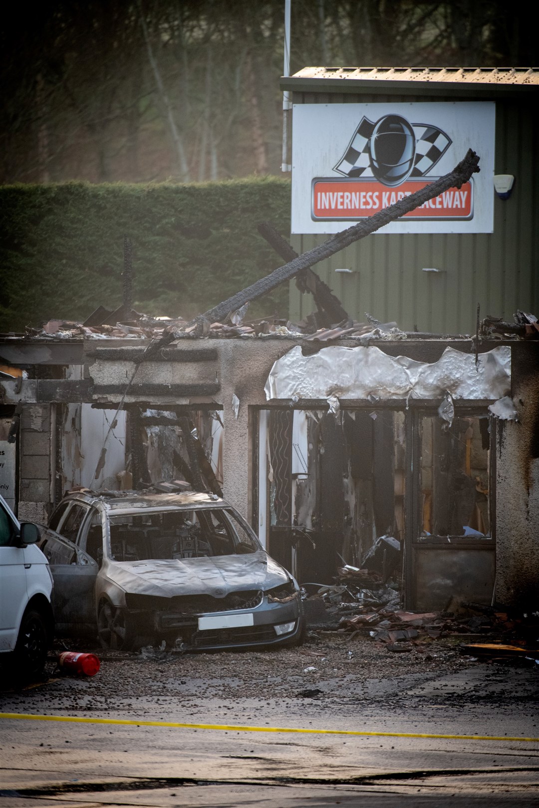 The devastated building which housed SJ Travel Centre. The fire destroyed the bases of several businesses, as well as a car, but firefighters were able to stop it spreading to neighbouring buildings such as the Inverness Kart Raceway (seen in the background of this shot). Picture: Callum Mackay.