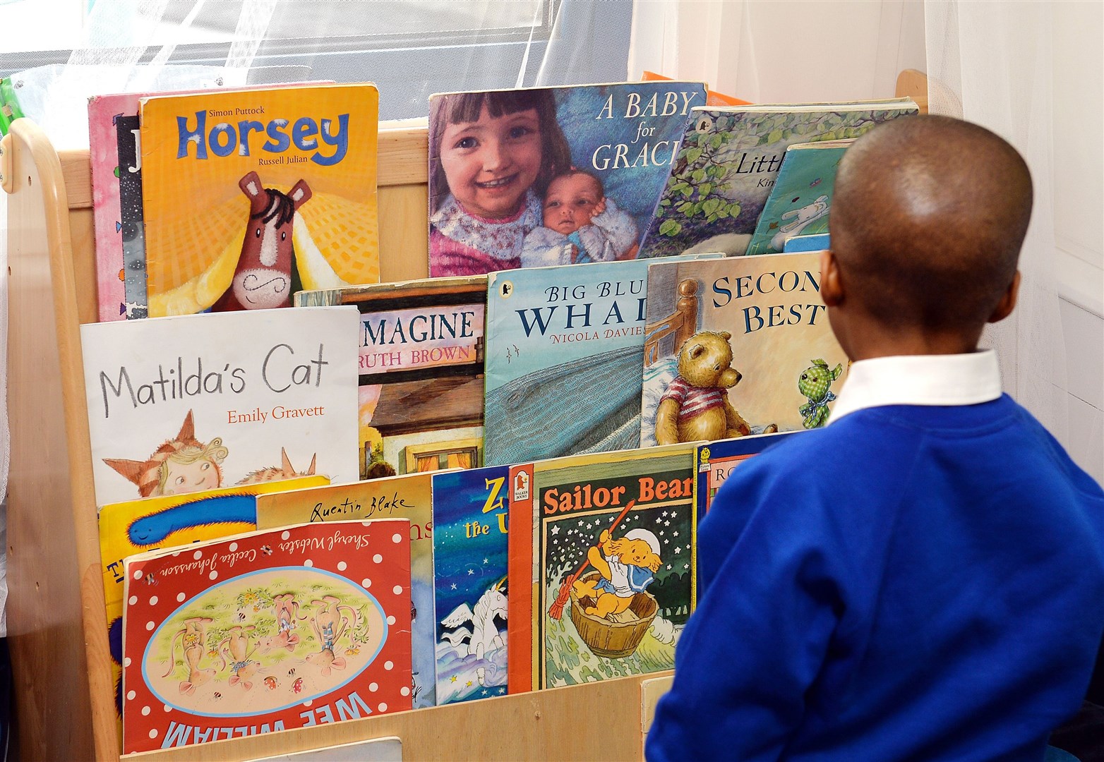 Giving young children phones makes it more difficult for them to engage in reading (John Stillwell/PA)