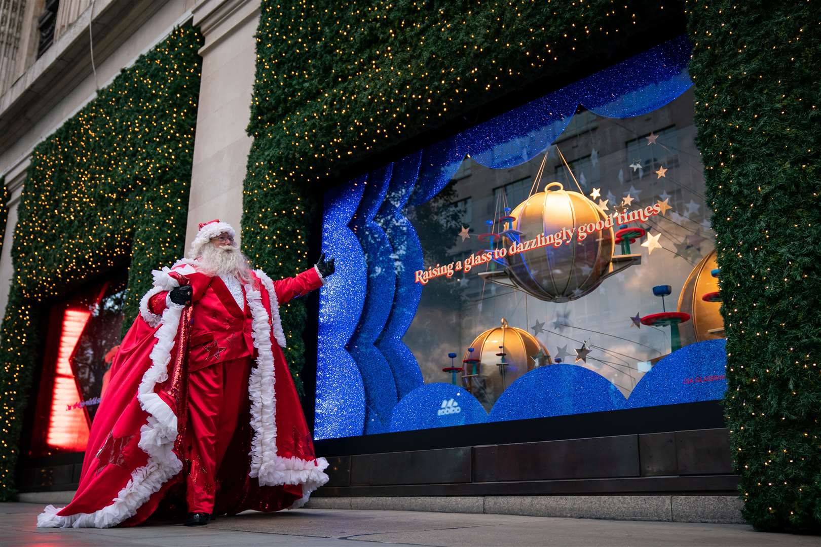 A man dressed as Santa Claus outside Selfridges in London as the department store unveils its Christmas windows (Aaron Chown/PA)