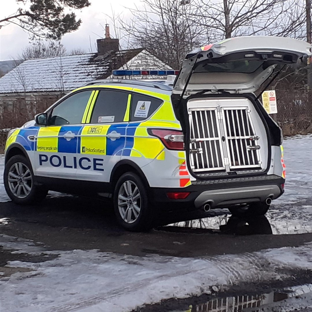 A police dog carrier pictured outside Kingussie High School today