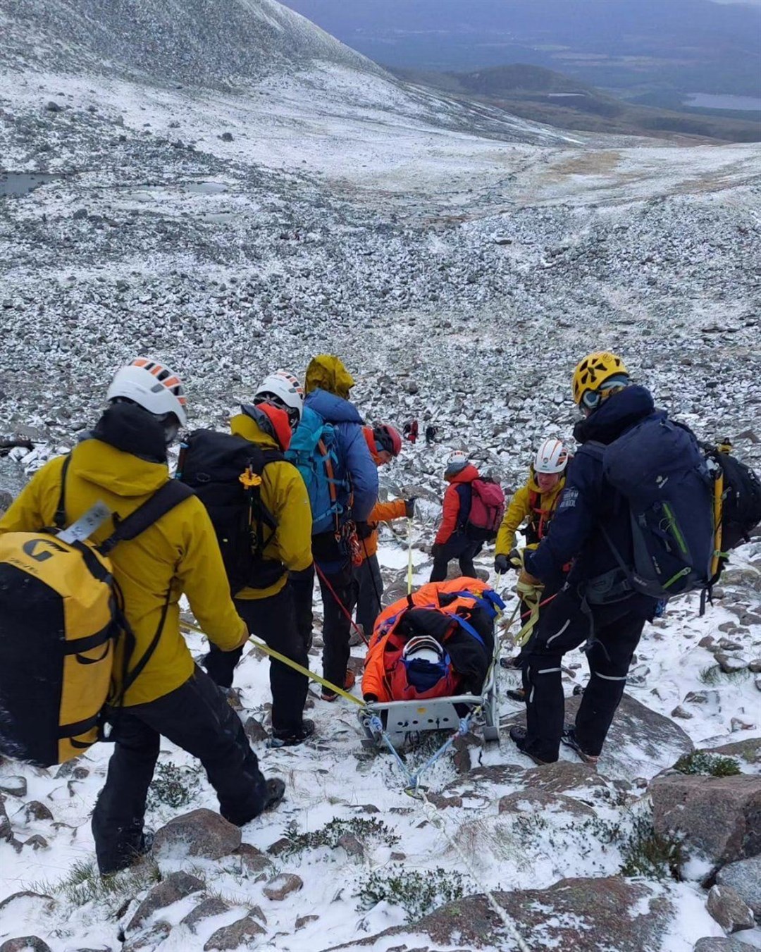 Members of the Cairngorm Mountain Rescue Team attend the injured climber.