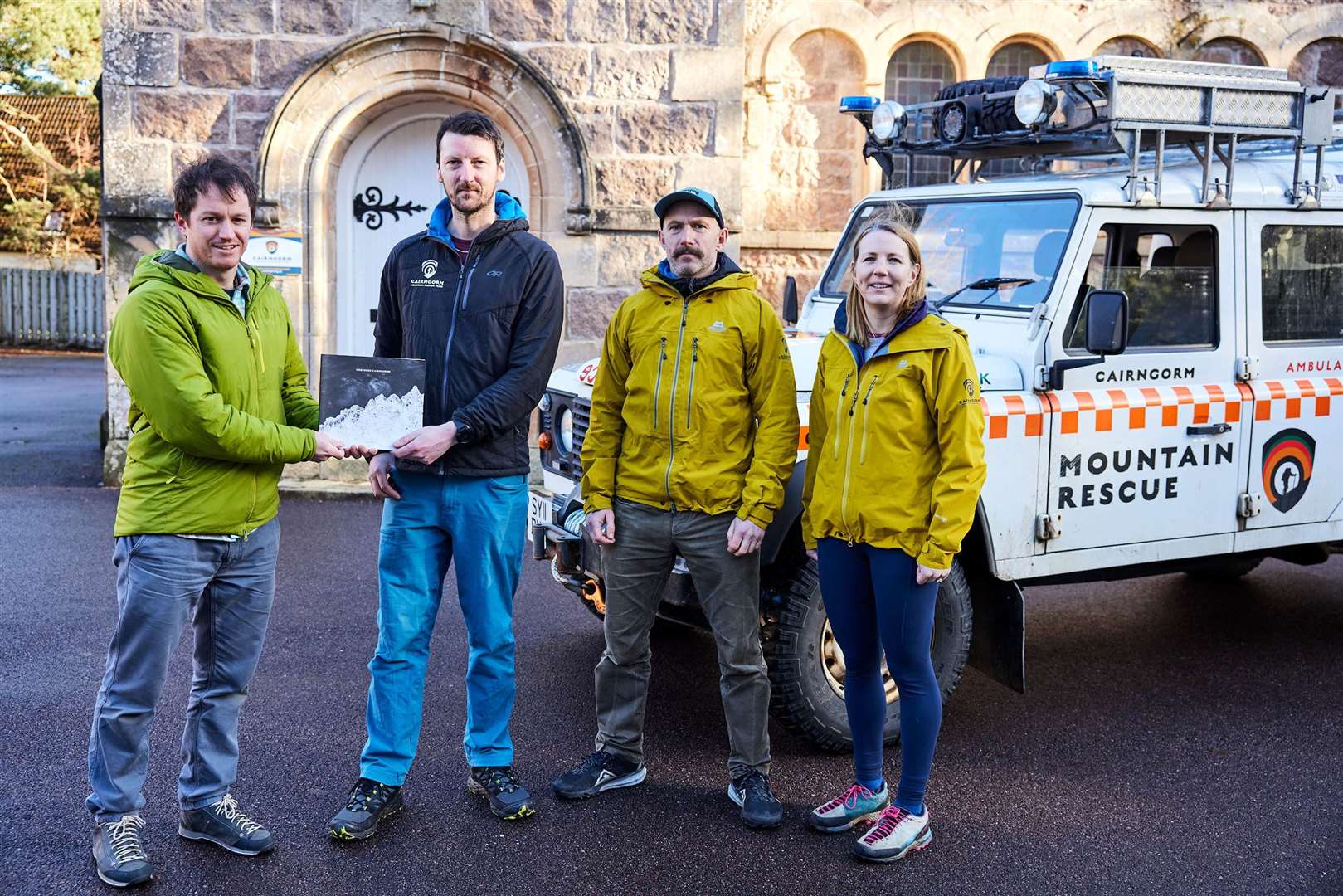 Ed (left) hands over more than £1000 to the heroes of the hill. With him are, from left, Conor Cromie Brian Fishpool and Gemma Munro.