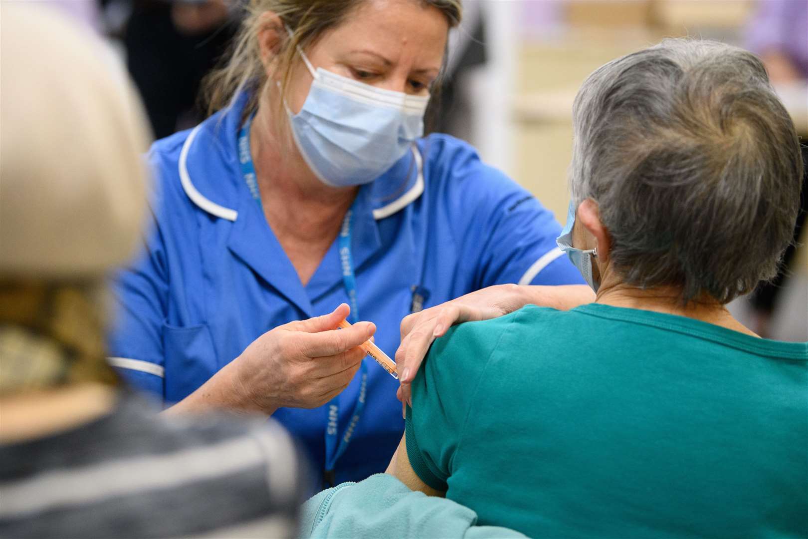 A member of the medical team administers a Covid-19 vaccine injection at the NHS vaccination centre in Robertson House, in Stevenage (Leon Neal/PA)